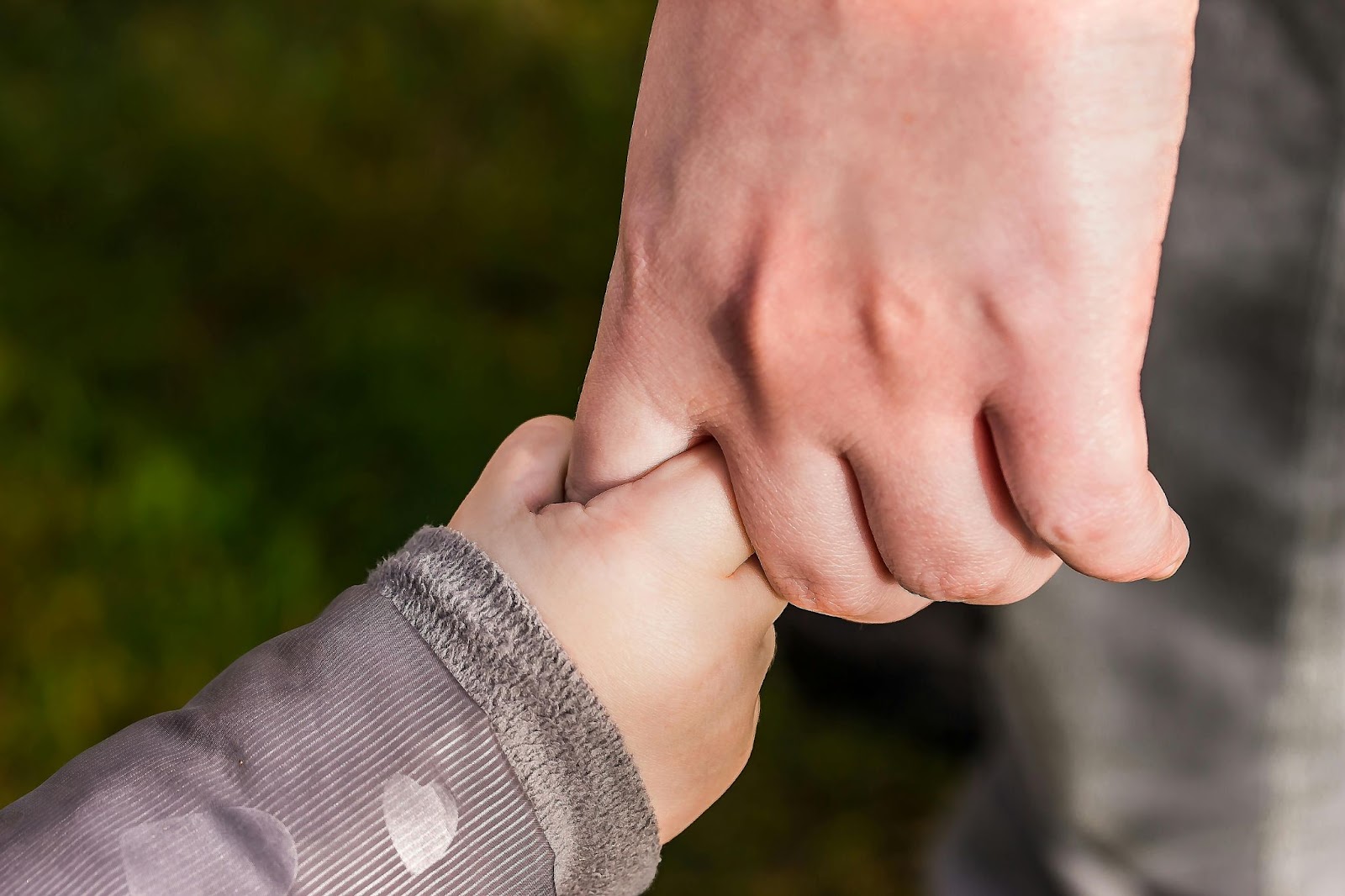 Mother holding toddlers hand